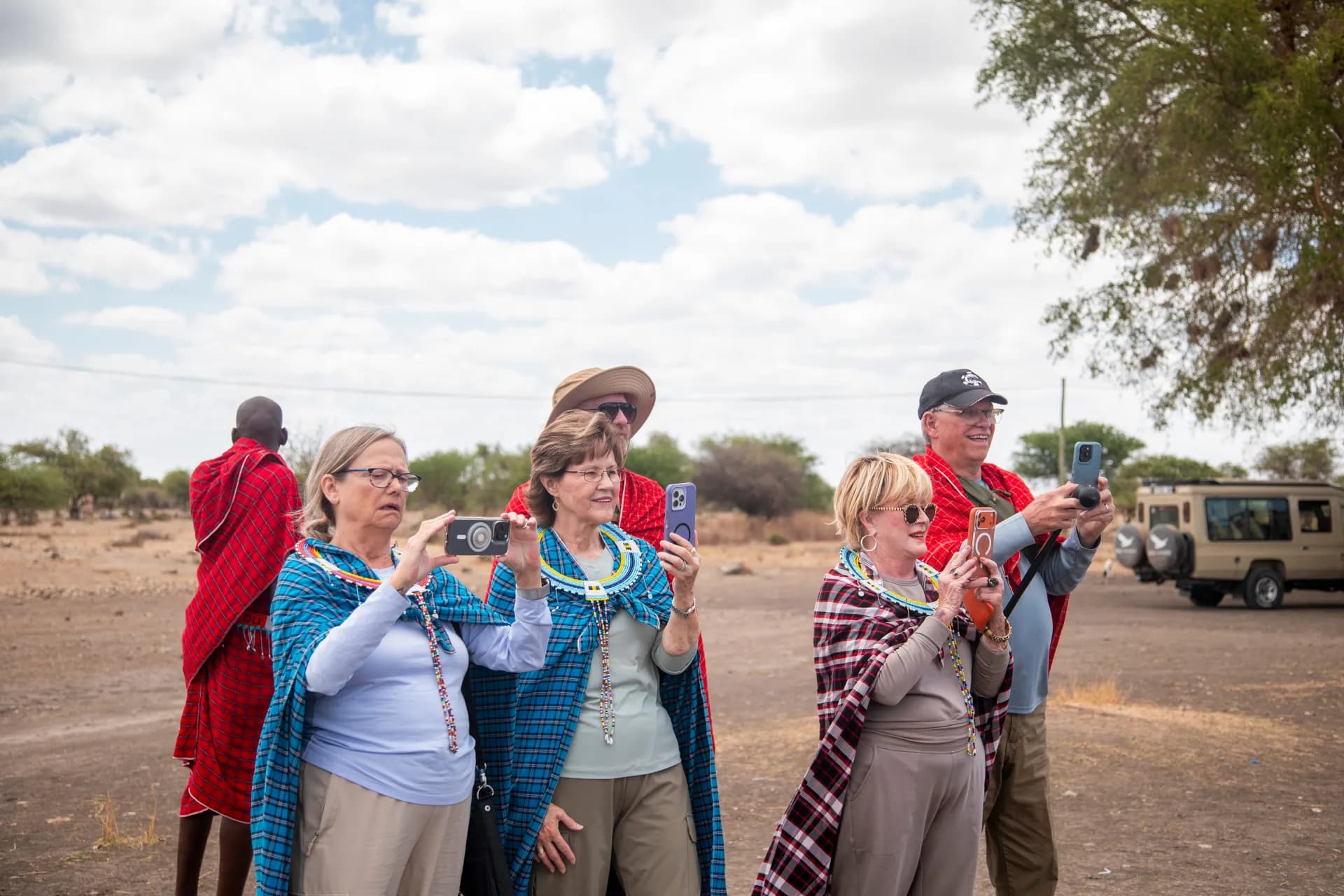 EXG guests take part in a traditional dress experience during a community visit