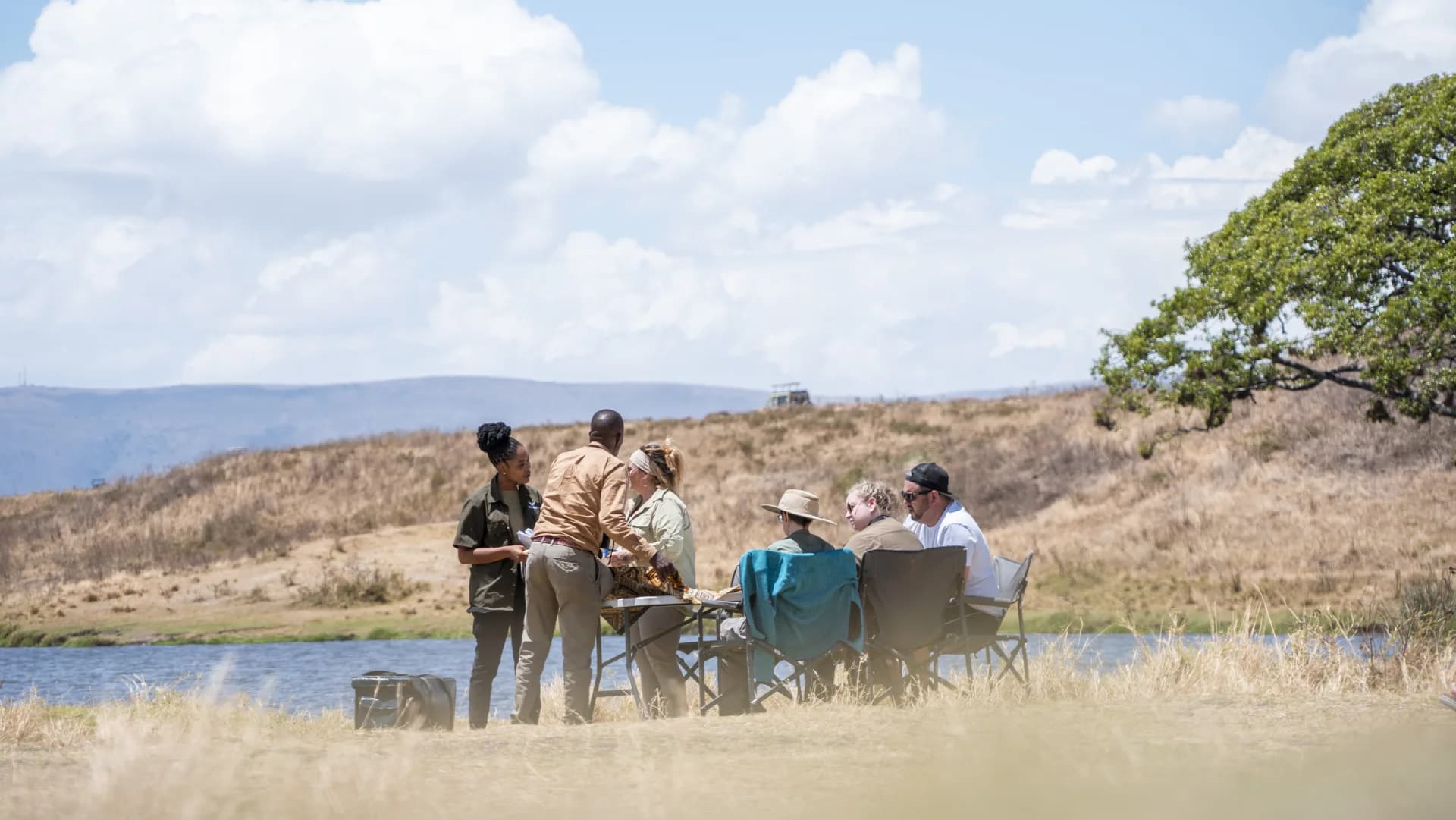 A family group with their guide at a bush lunch briefing in Tanzania