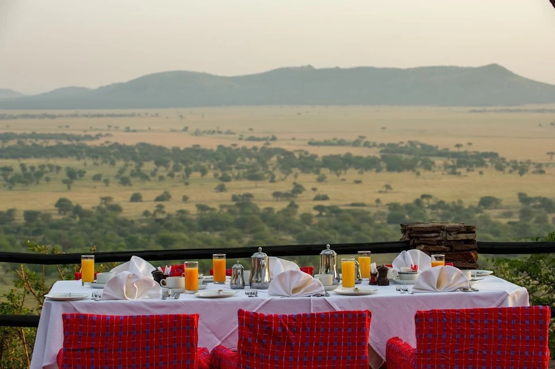A private breakfast setting overlooking the Serengeti at a top-tier lodge